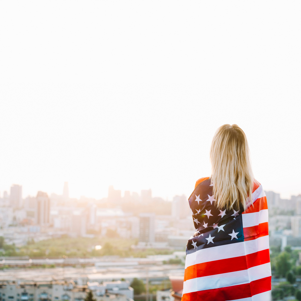 A girl with the American flag wrapped around her